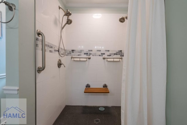 bathroom with ornamental molding and a stall shower