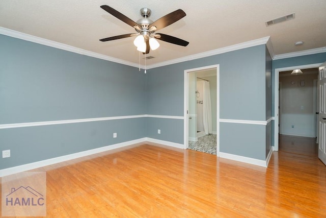 unfurnished bedroom featuring ornamental molding, visible vents, light wood-style flooring, and baseboards