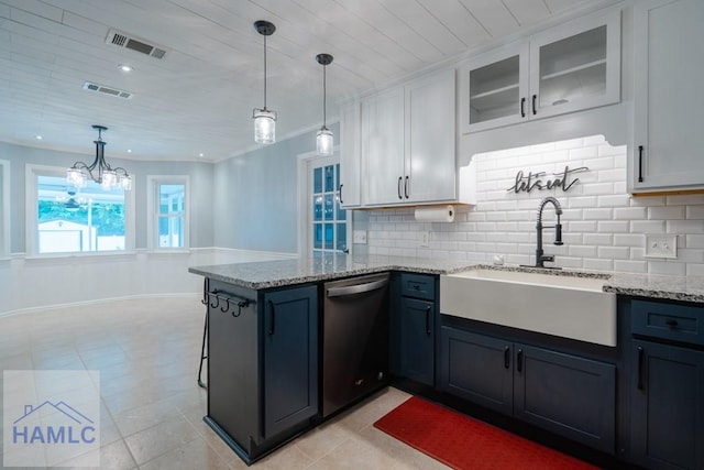 kitchen featuring a sink, dishwasher, a peninsula, and visible vents