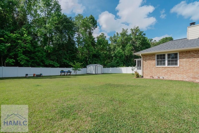 view of yard with an outbuilding, a storage shed, and a fenced backyard