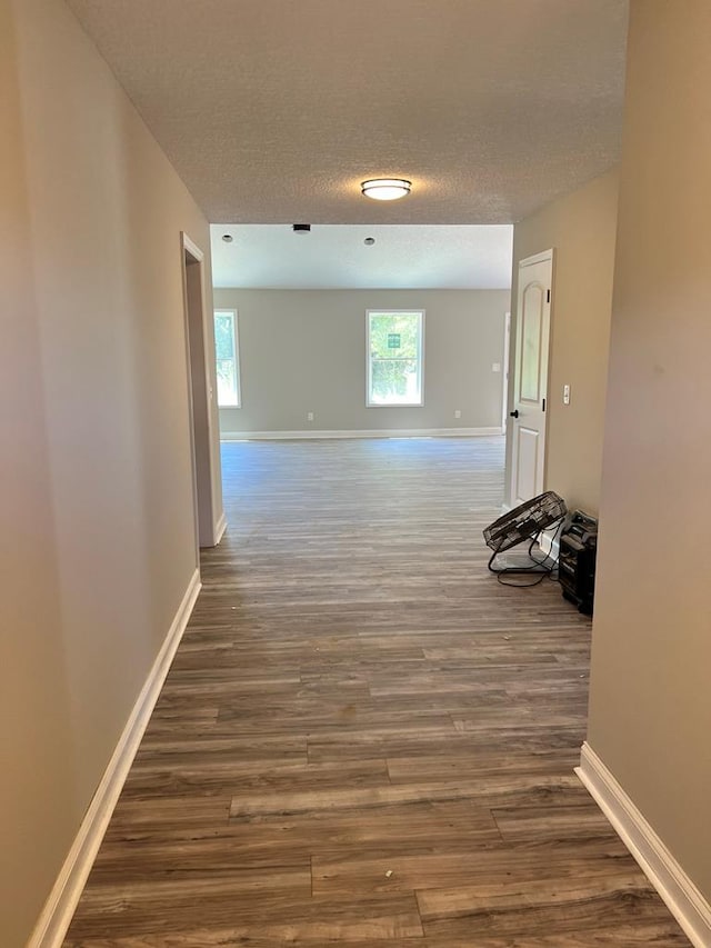 hall featuring dark hardwood / wood-style flooring and a textured ceiling