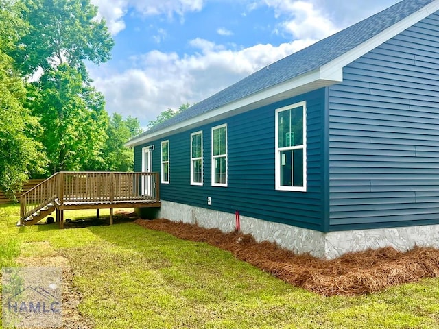 556 Caleb Cir, Jesup, GA 31545 - view of side of property with a deck, a yard, and roof with shingles