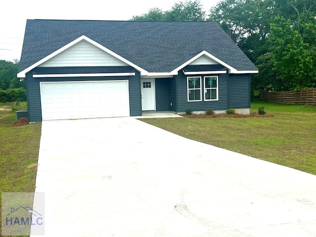 556 Caleb Cir, Jesup, GA 31545 - ranch-style house featuring a shingled roof, a garage, and driveway