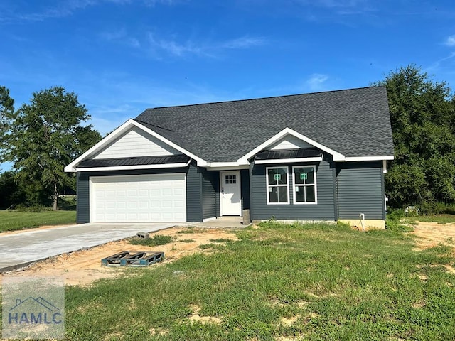 ranch-style house with a garage and a front lawn