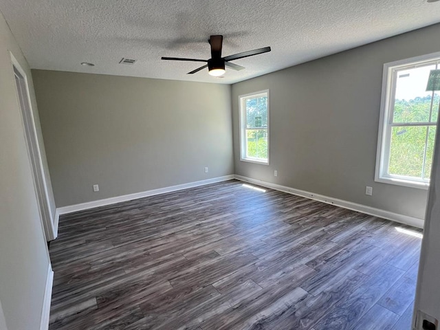 556 Caleb Cir, Jesup, GA 31545 - spare room with dark wood-style floors, ceiling fan, a textured ceiling, and baseboards