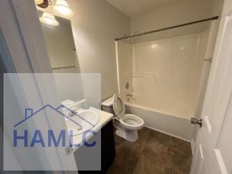 bathroom featuring vanity, washtub / shower combination, and toilet
