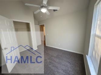 unfurnished bedroom with a ceiling fan, baseboards, carpet, and a closet