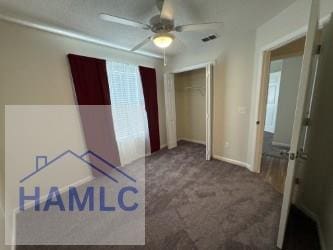 unfurnished bedroom featuring carpet flooring, a ceiling fan, baseboards, and a closet