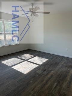 empty room featuring baseboards and wood finished floors