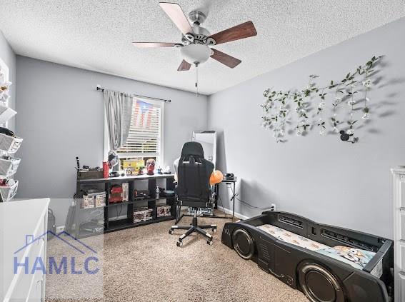 home office featuring ceiling fan and a textured ceiling