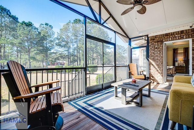 sunroom / solarium with ceiling fan and lofted ceiling