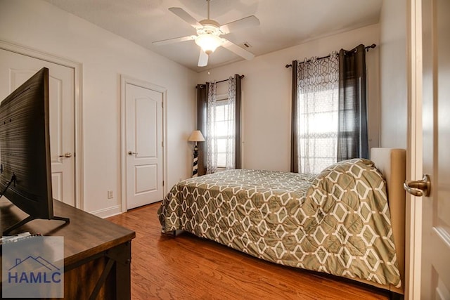 bedroom featuring hardwood / wood-style floors and ceiling fan