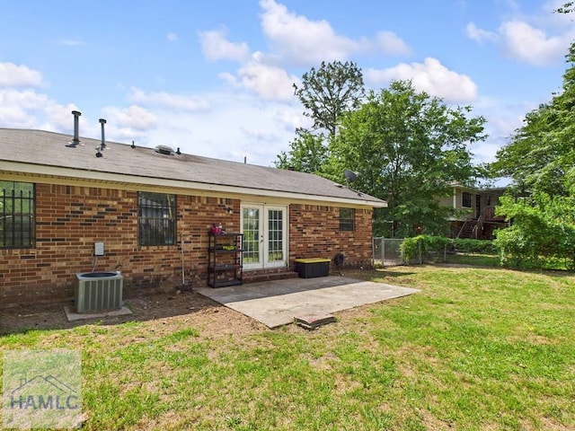 back of house featuring french doors, a patio, central air condition unit, and brick siding