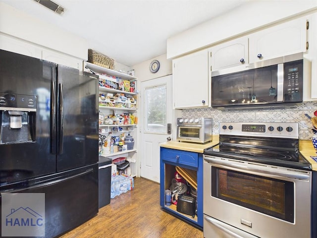 kitchen featuring appliances with stainless steel finishes, white cabinets, backsplash, and wood finished floors