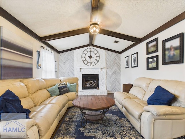 living area featuring ceiling fan, a high end fireplace, and ornamental molding