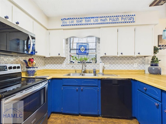 kitchen featuring stainless steel appliances, a sink, blue cabinets, tasteful backsplash, and white cabinets
