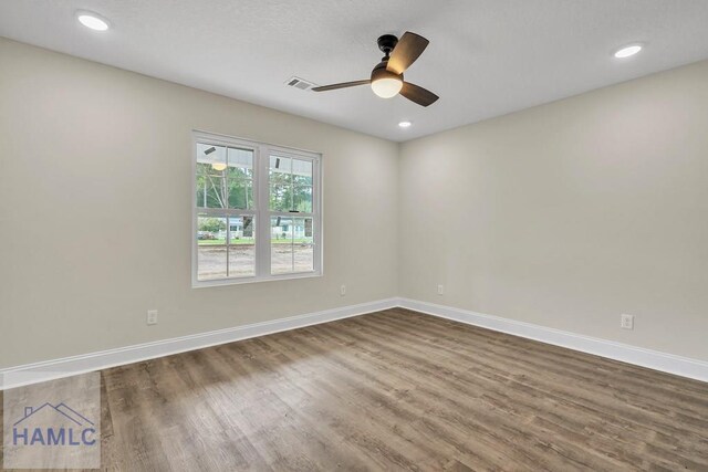 empty room featuring dark hardwood / wood-style floors and ceiling fan