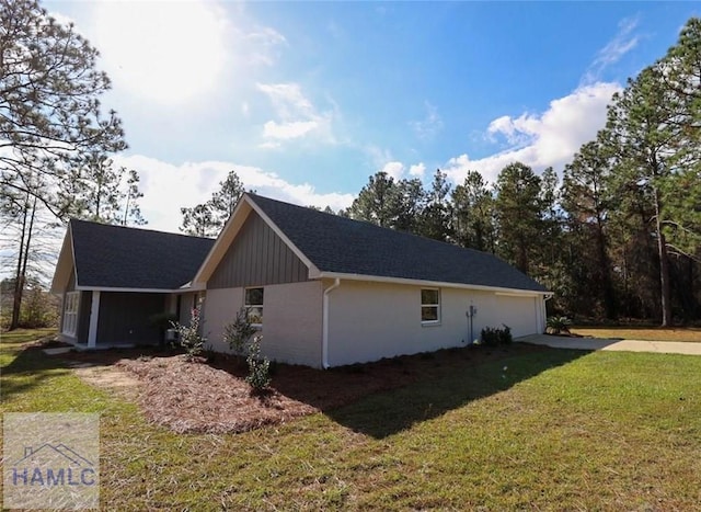 210 Sugar Maple St, Jesup, GA 31546 - view of side of home featuring concrete driveway, a yard, and a garage