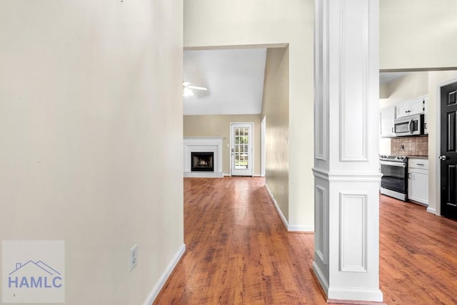 hallway with baseboards and wood finished floors