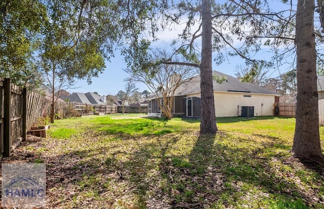 view of yard featuring a fenced backyard and central air condition unit