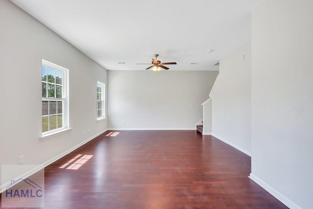 89 Morgan Field Blvd, Ludowici, GA 31316 - unfurnished living room featuring a ceiling fan, wood finished floors, stairs, and baseboards