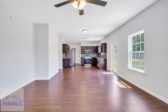 89 Morgan Field Blvd, Ludowici, GA 31316 - unfurnished living room featuring ceiling fan, dark wood-style flooring, baseboards, and a sink