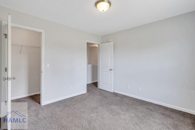89 Morgan Field Blvd, Ludowici, GA 31316 - unfurnished bedroom featuring carpet, baseboards, a closet, and a walk in closet