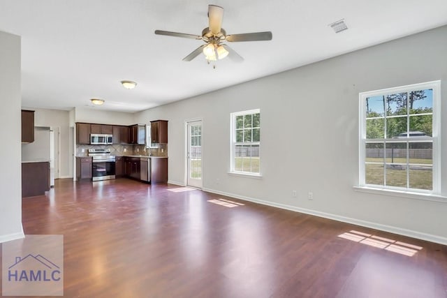 89 Morgan Field Blvd, Ludowici, GA 31316 - unfurnished living room featuring plenty of natural light, baseboards, and dark wood finished floors