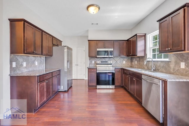 89 Morgan Field Blvd, Ludowici, GA 31316 - kitchen featuring stainless steel appliances, a sink, dark wood-type flooring, and light stone countertops