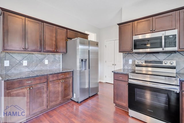 89 Morgan Field Blvd, Ludowici, GA 31316 - kitchen with stainless steel appliances, stone counters, dark wood-type flooring, and decorative backsplash