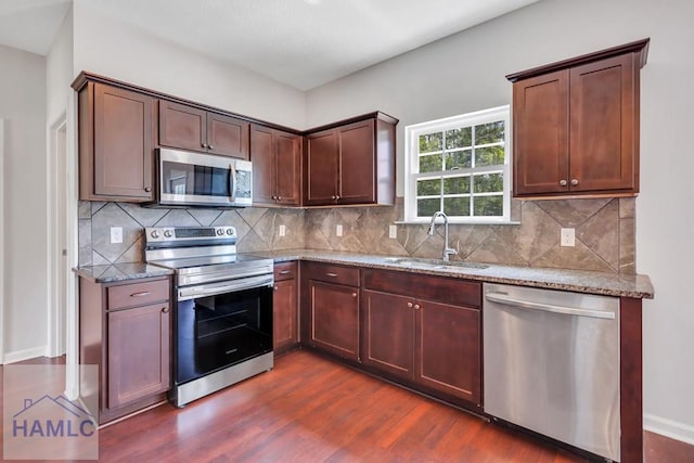 89 Morgan Field Blvd, Ludowici, GA 31316 - kitchen featuring stainless steel appliances, a sink, dark wood-style flooring, light stone countertops, and tasteful backsplash