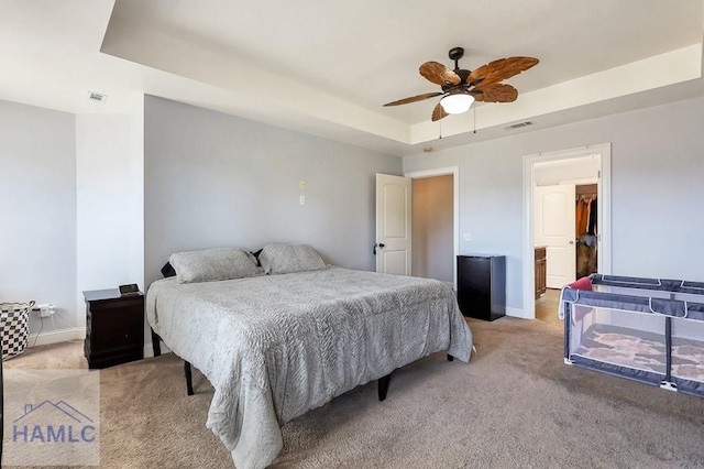 243 Forest St, Ludowici, GA 31316 - bedroom featuring light carpet, a ceiling fan, baseboards, a tray ceiling, and visible vents