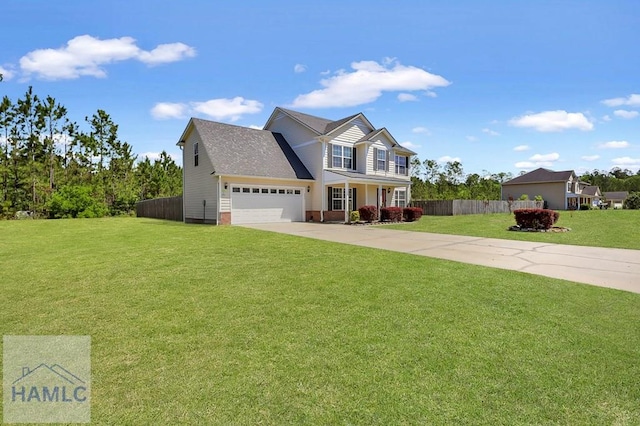 243 Forest St, Ludowici, GA 31316 - view of front of home featuring an attached garage, fence, driveway, and a front yard