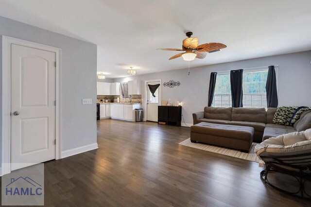 243 Forest St, Ludowici, GA 31316 - living area featuring dark wood-type flooring, a ceiling fan, and baseboards