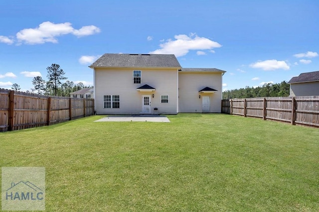 243 Forest St, Ludowici, GA 31316 - rear view of house with a fenced backyard, a patio, and a yard