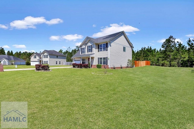 243 Forest St, Ludowici, GA 31316 - view of front of house with a garage, fence, concrete driveway, and a front lawn
