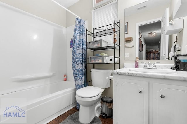 124 Deann Dr, Hinesville, GA 31313 - full bathroom with vanity, wood finished floors, toilet, and shower / bathtub combination with curtain
