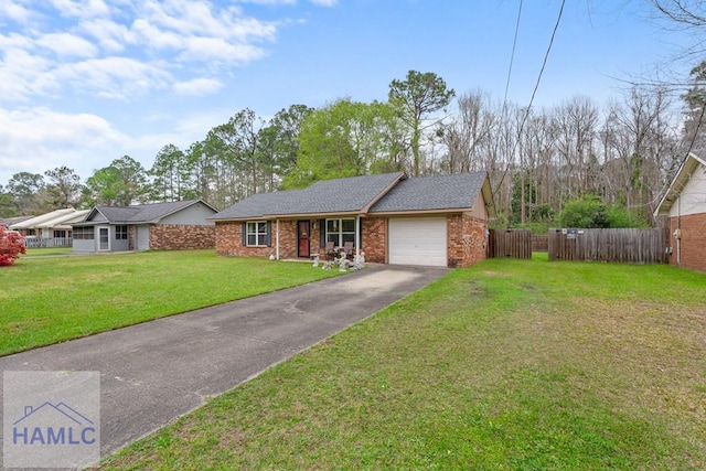 124 Deann Dr, Hinesville, GA 31313 - view of front of home with an attached garage, asphalt driveway, and brick siding