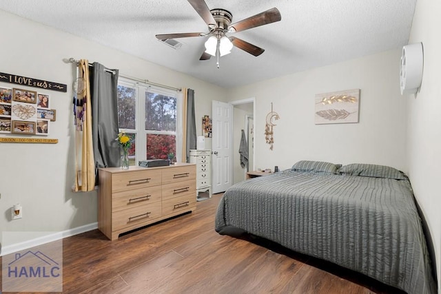 124 Deann Dr, Hinesville, GA 31313 - bedroom with dark wood finished floors, a textured ceiling, a ceiling fan, and baseboards