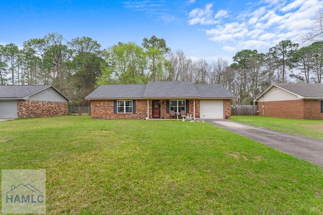 124 Deann Dr, Hinesville, GA 31313 - single story home with asphalt driveway, an attached garage, covered porch, and brick siding