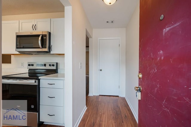 727S Main St Unit 121, Hinesville, GA 31313 - kitchen with stainless steel appliances, wood finished floors, white cabinets, and light countertops
