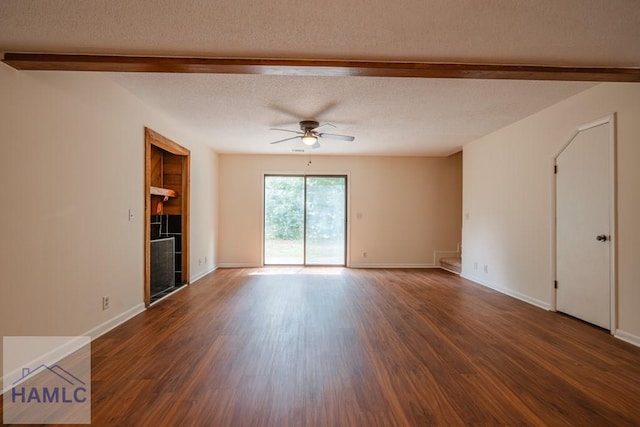 727S Main St Unit 121, Hinesville, GA 31313 - spare room featuring a ceiling fan, beam ceiling, wood finished floors, a tiled fireplace, and a textured ceiling