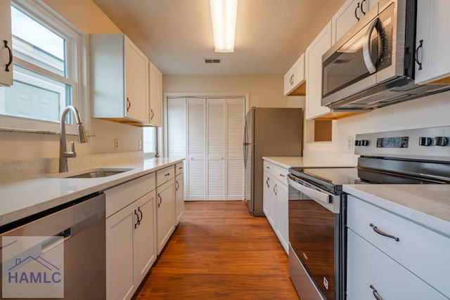 727S Main St Unit 121, Hinesville, GA 31313 - kitchen featuring appliances with stainless steel finishes, wood finished floors, light countertops, and white cabinets
