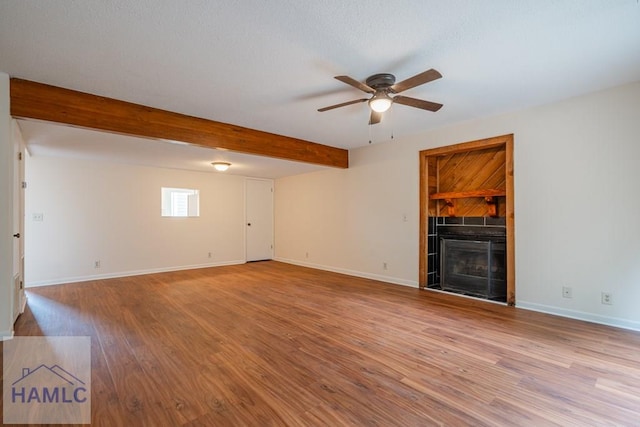 727S Main St Unit 121, Hinesville, GA 31313 - unfurnished living room with a ceiling fan, a fireplace, wood finished floors, and beam ceiling