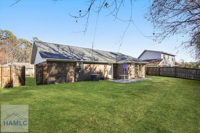 rear view of house with a yard