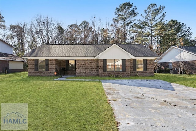 ranch-style home with central air condition unit and a front lawn