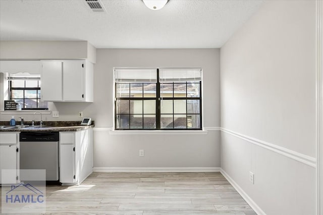 kitchen with white cabinets, a textured ceiling, sink, dishwasher, and light hardwood / wood-style floors