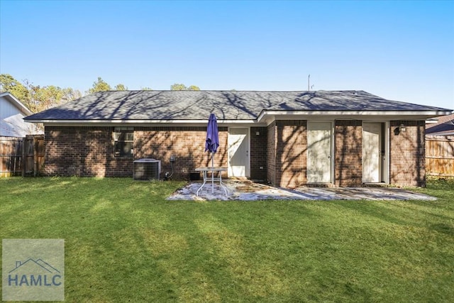 back of property featuring a lawn and cooling unit