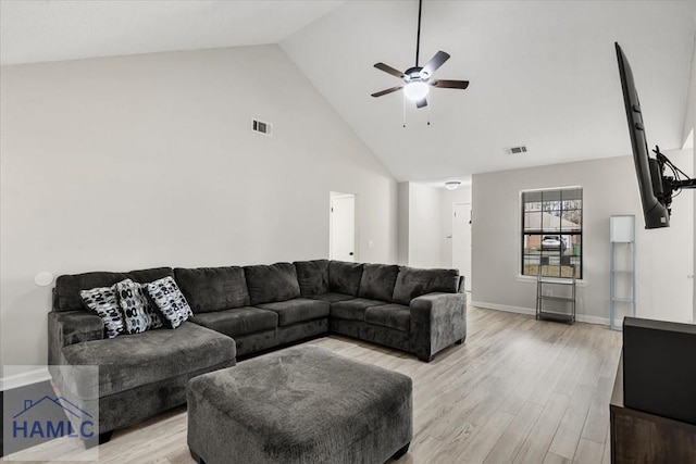 living room featuring ceiling fan, light wood-type flooring, and high vaulted ceiling