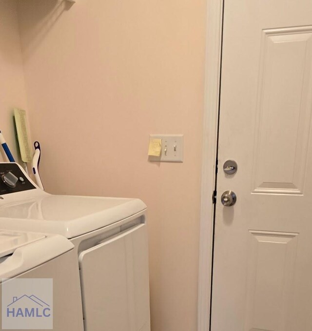 washroom with washing machine and dryer and laundry area